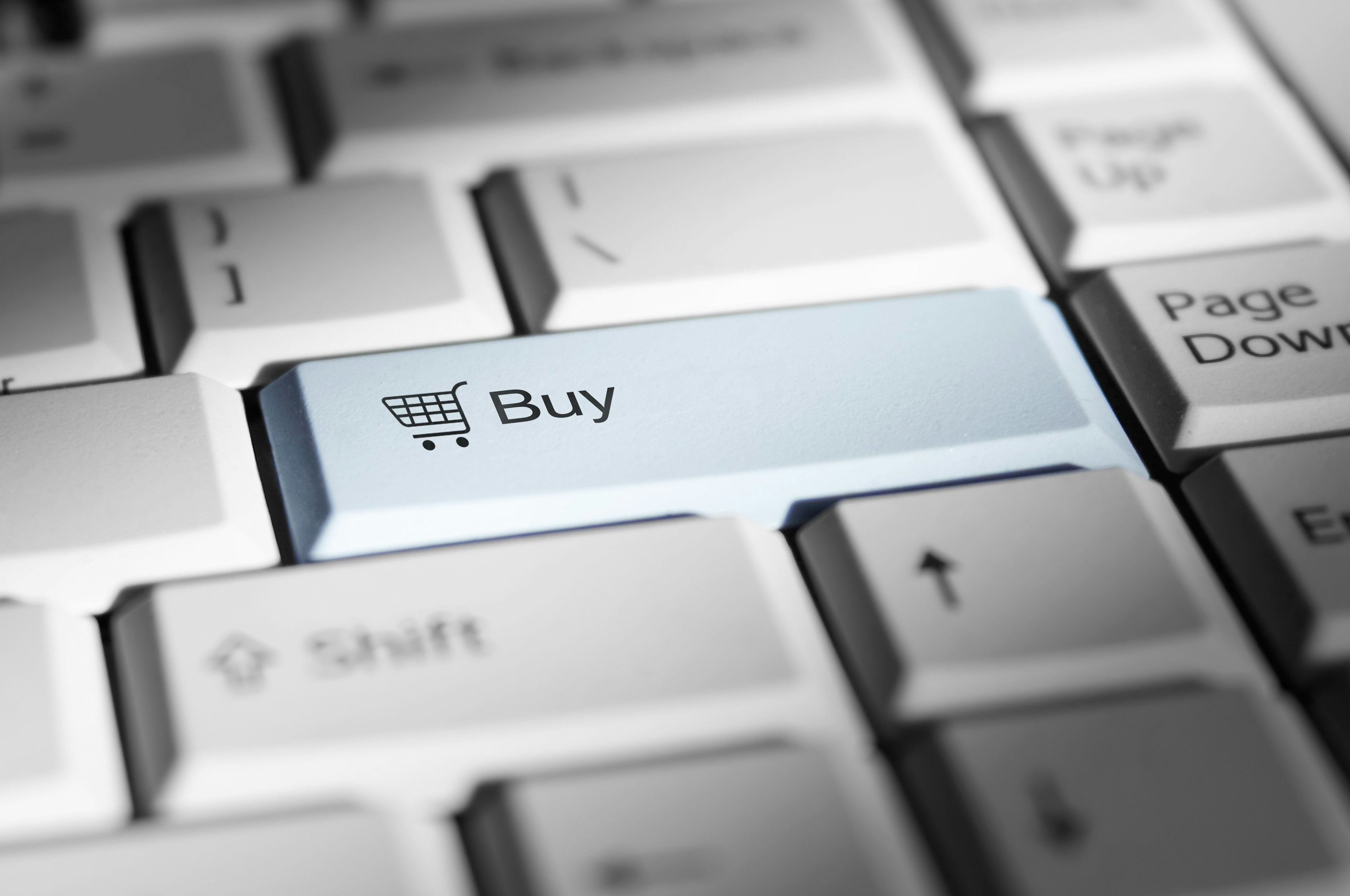 zoomed in on a computer keyboard, showing a Buy button above the Shift button zoomed in on a computer keyboard, showing a Buy button above the Shift button