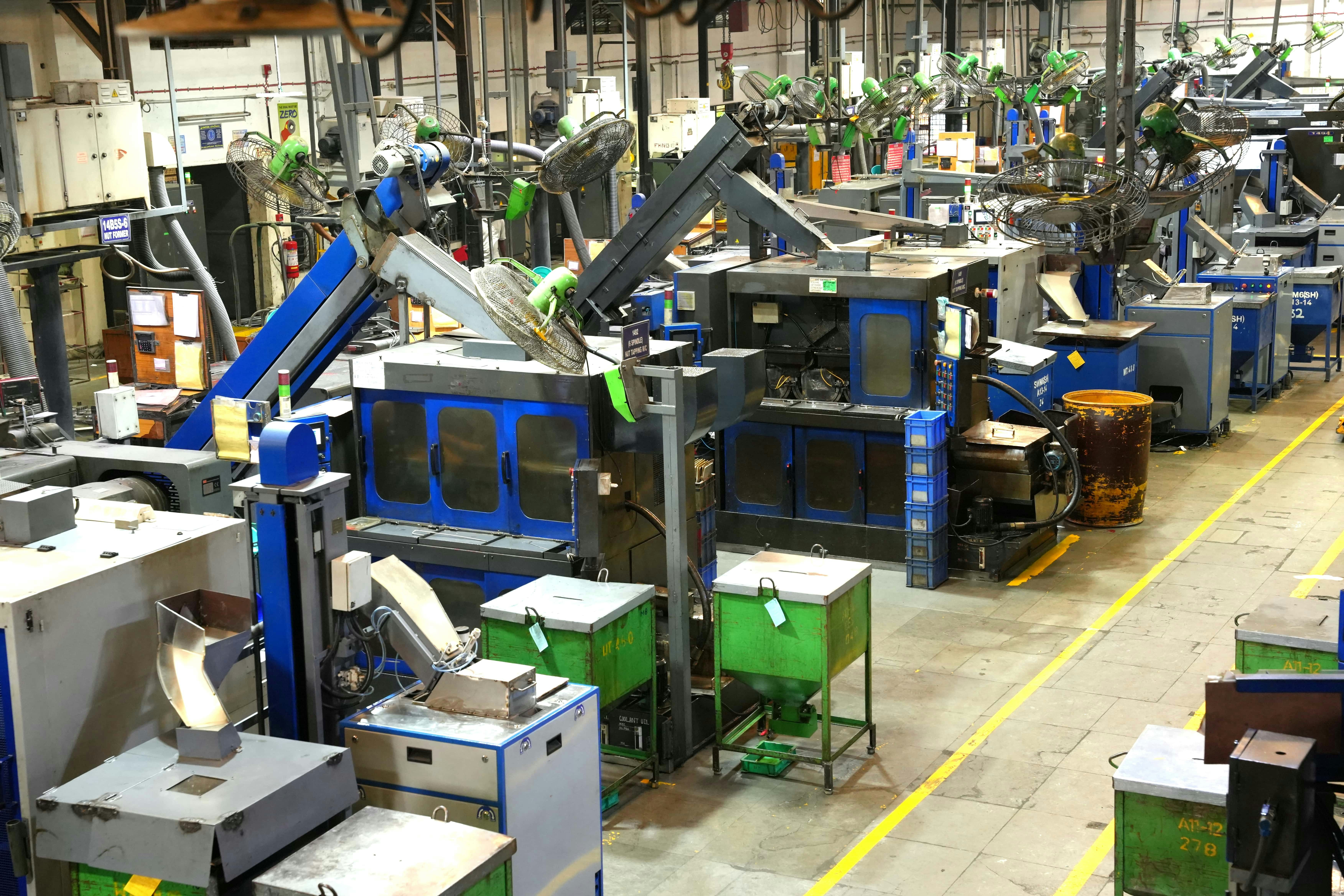 Industrial factory floor with machines and yellow lines Industrial factory floor with machines and yellow lines